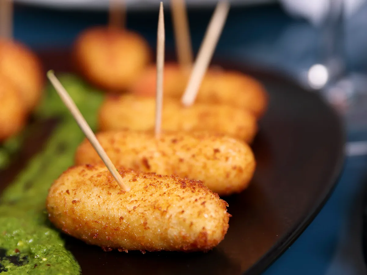 Foto de Croquetas de jamón serrano y queso manchego con salsa de pesto y tomaca